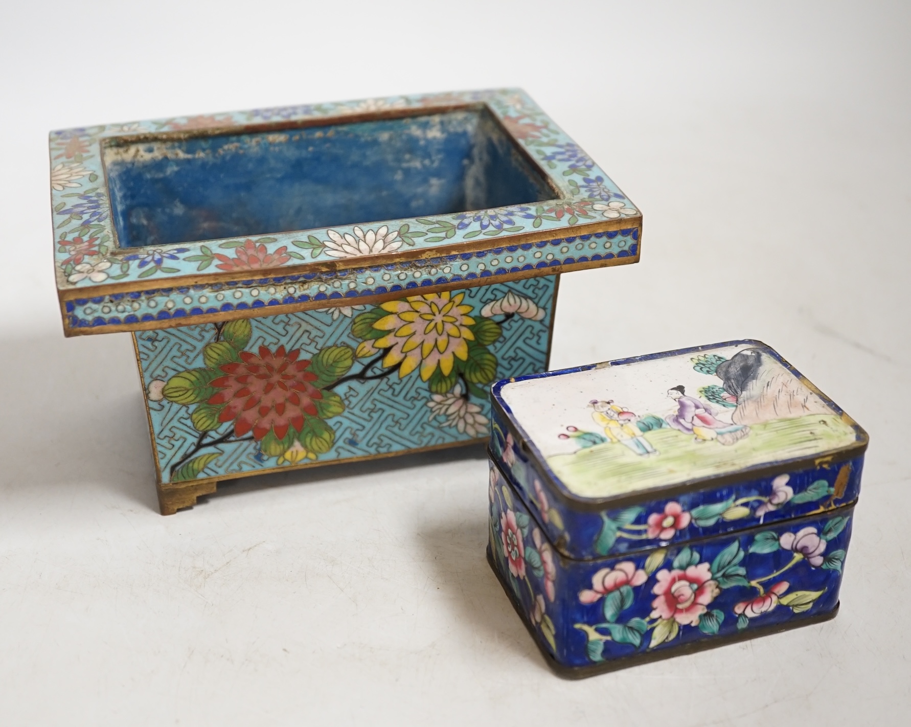 A Chinese cloisonné enamel floral jardiniere and a Canton enamel box and cover depicting two figures before a landscape, largest 16cm wide. Condition - poor to fair